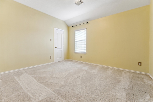 unfurnished room with light carpet and vaulted ceiling