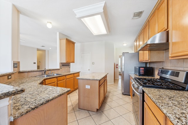 kitchen with stainless steel gas stove, a center island, light stone counters, kitchen peninsula, and exhaust hood