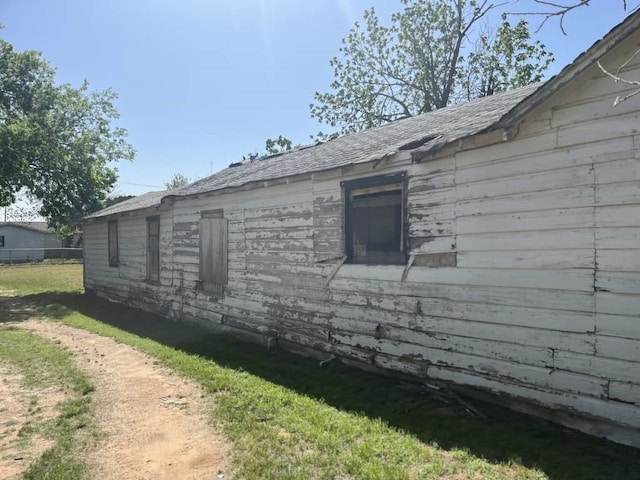 view of property exterior featuring a lawn