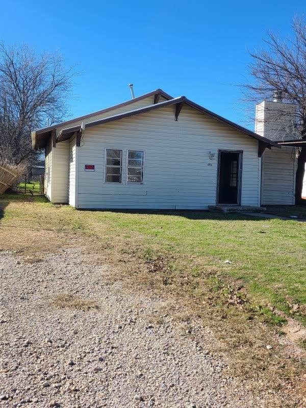 rear view of house with a lawn