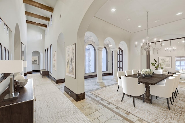 dining area featuring recessed lighting, arched walkways, decorative columns, baseboards, and a towering ceiling