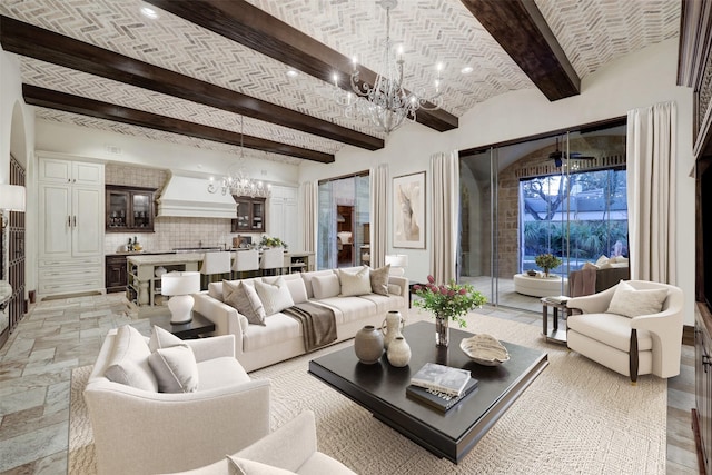 living room featuring beamed ceiling, brick ceiling, and a notable chandelier