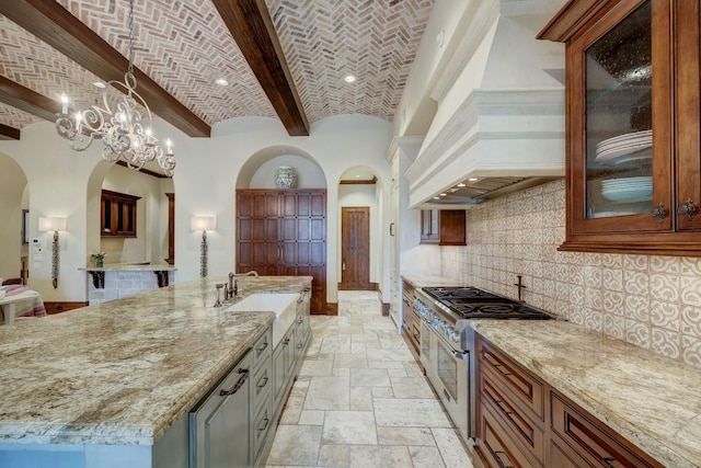 kitchen featuring pendant lighting, brick ceiling, high end range, a spacious island, and custom range hood