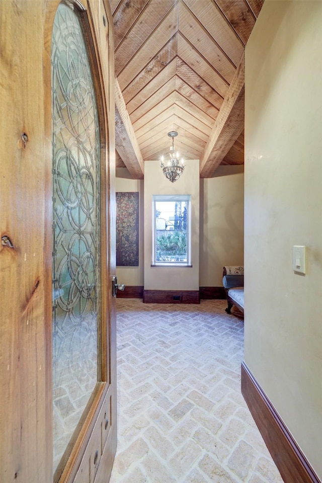 hallway with beam ceiling, a notable chandelier, and wood ceiling