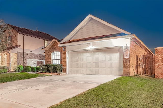 view of front of property featuring a garage and a front lawn