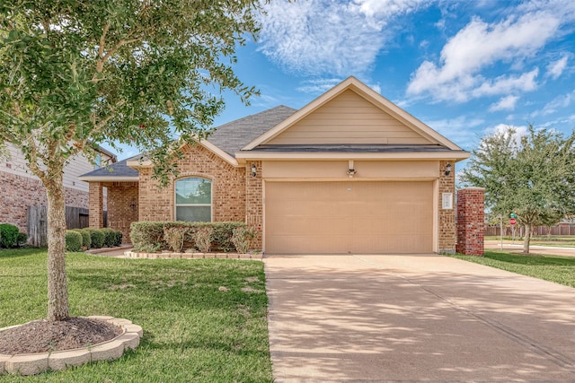 view of front of home with a front lawn and a garage