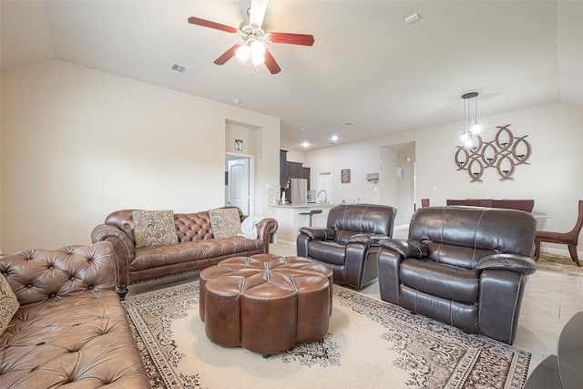 living room with ceiling fan and vaulted ceiling