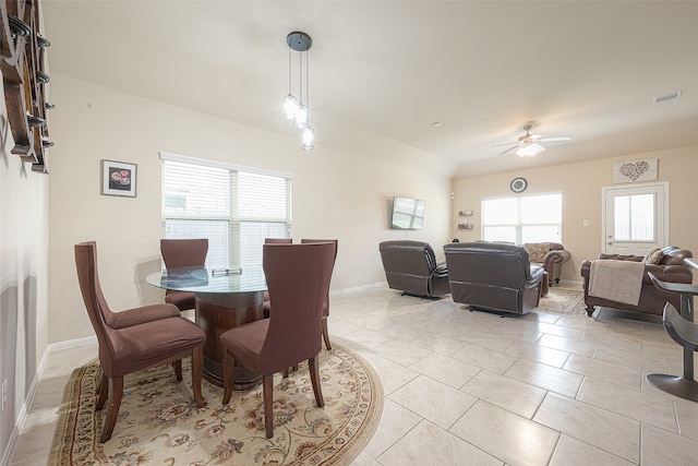 dining space with ceiling fan and light tile patterned floors