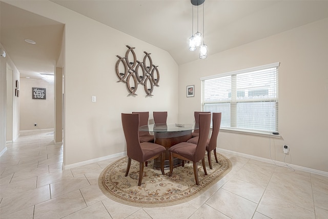 tiled dining room with lofted ceiling