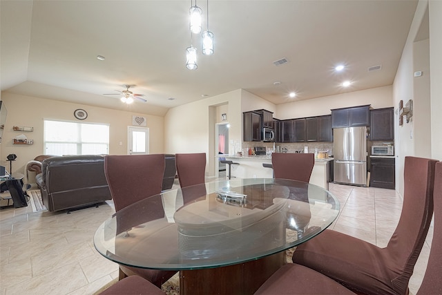 dining space featuring ceiling fan and light tile patterned floors