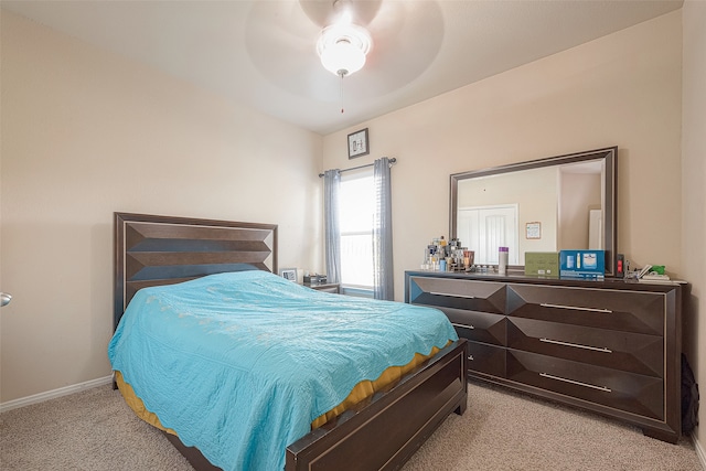 bedroom with ceiling fan and light carpet