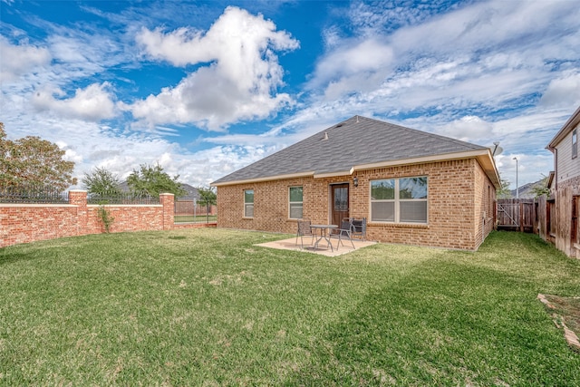 back of house with a lawn and a patio