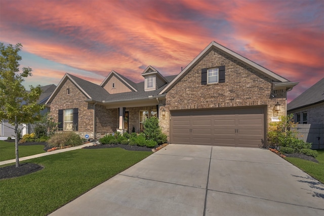 view of front of property with a yard and a garage