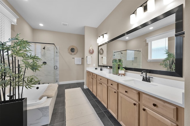 bathroom with plus walk in shower, tile patterned flooring, and vanity