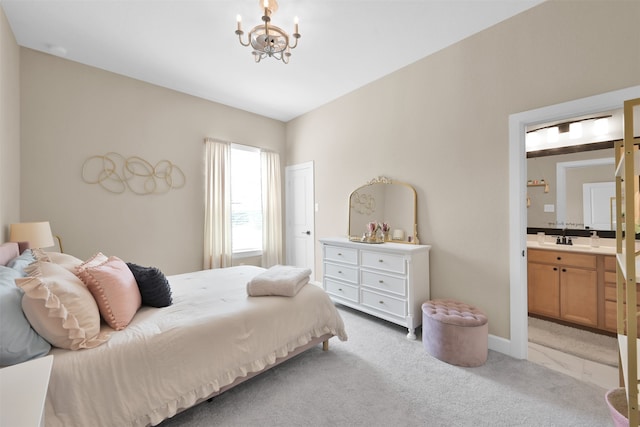 bedroom with connected bathroom, sink, light colored carpet, and an inviting chandelier