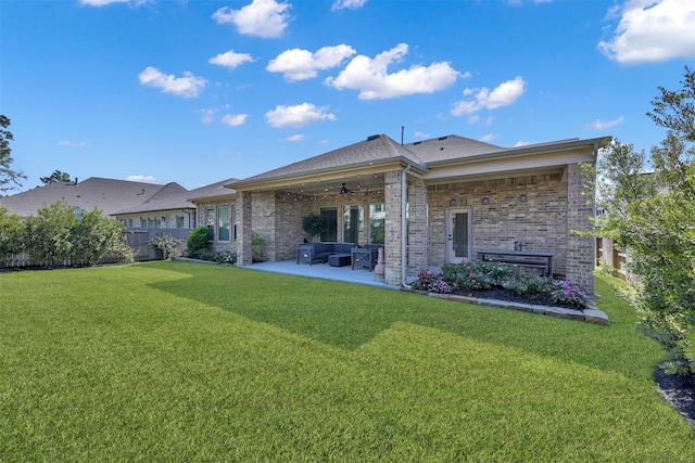 rear view of property with a lawn, a patio area, ceiling fan, and outdoor lounge area