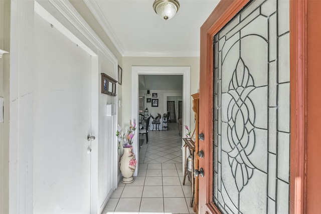 entryway with light tile patterned flooring and crown molding