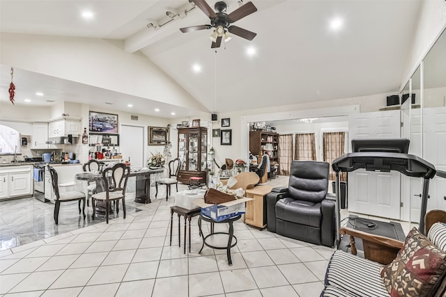 living room featuring beam ceiling, ceiling fan, and high vaulted ceiling