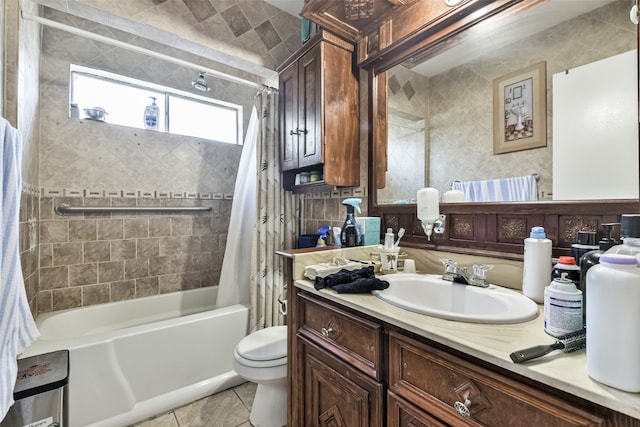 full bathroom featuring vanity, tile patterned floors, toilet, shower / bathtub combination with curtain, and tile walls