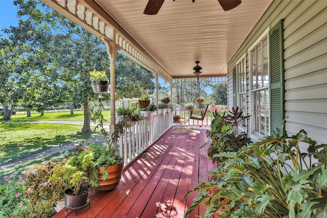 deck with ceiling fan and a porch