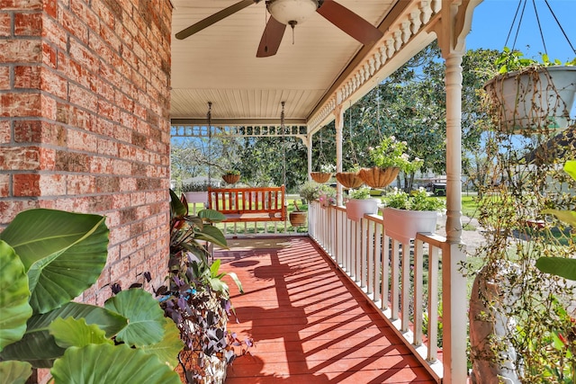 deck with ceiling fan and covered porch