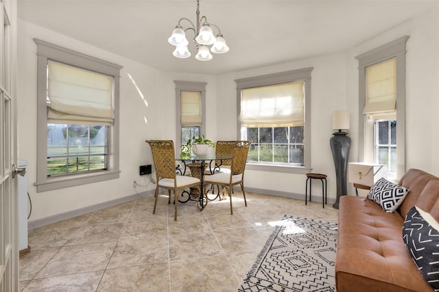 tiled dining room featuring an inviting chandelier