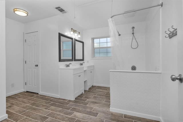 bathroom with hardwood / wood-style floors, vanity, and a shower with curtain