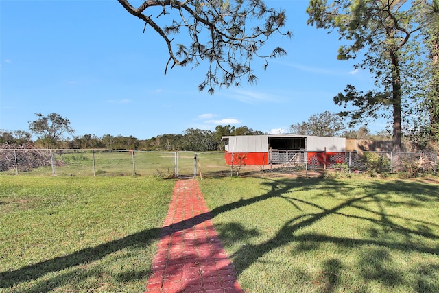 view of yard with a rural view and an outdoor structure