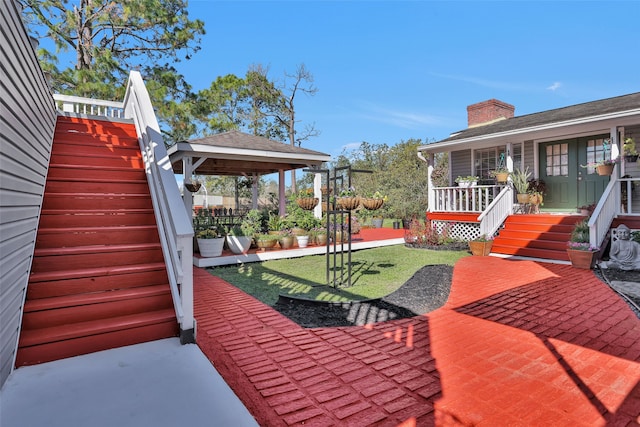 view of patio / terrace with a gazebo and covered porch