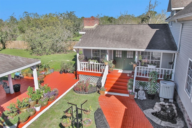 deck featuring a yard, cooling unit, and covered porch