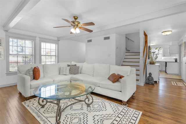 living room with dark hardwood / wood-style flooring and ceiling fan