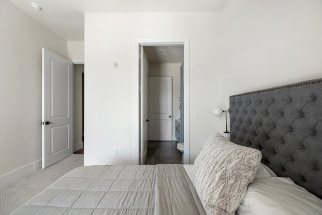 carpeted bedroom featuring ensuite bathroom