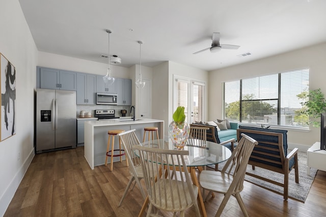 dining room with dark hardwood / wood-style floors, ceiling fan, and sink