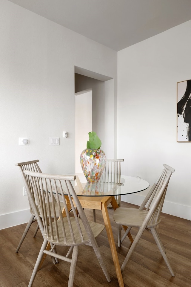 dining space with dark wood-type flooring