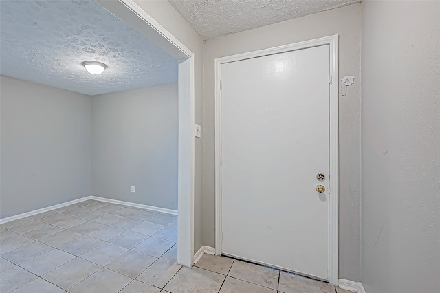 tiled foyer featuring a textured ceiling