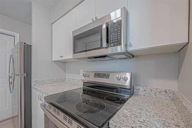 kitchen featuring white cabinetry and appliances with stainless steel finishes