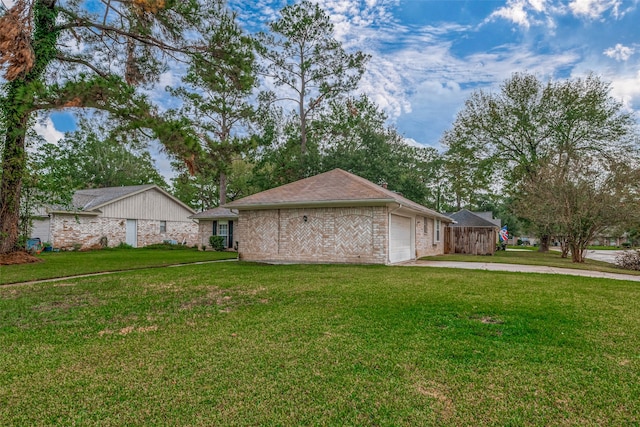 exterior space with a garage and a lawn