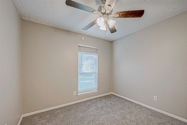 unfurnished room featuring a textured ceiling, light colored carpet, and ceiling fan