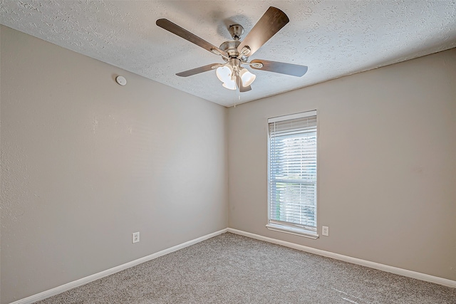 carpeted empty room featuring ceiling fan and a textured ceiling