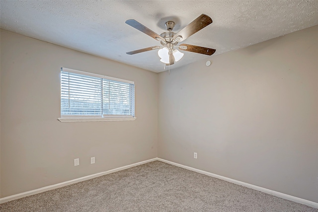 carpeted spare room with a textured ceiling and ceiling fan