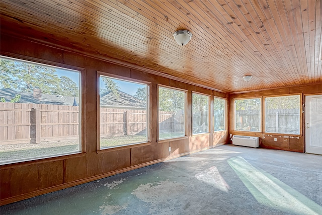 unfurnished sunroom with an AC wall unit and wood ceiling