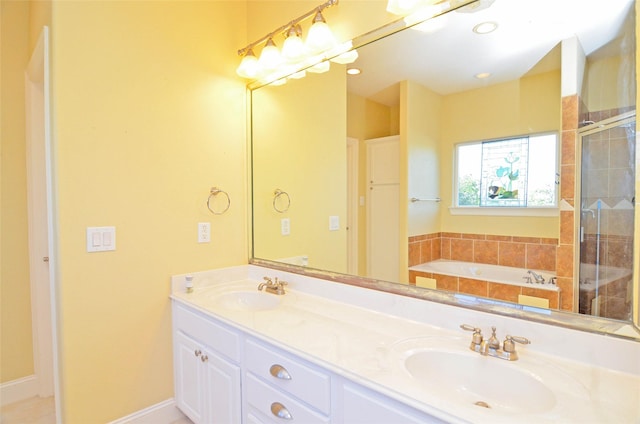 bathroom with vanity and independent shower and bath