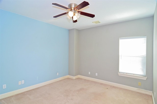 empty room with light colored carpet and ceiling fan