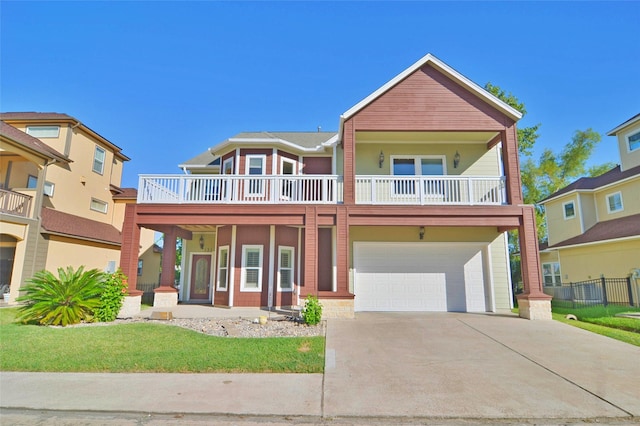 view of front of home with a garage, a balcony, and covered porch