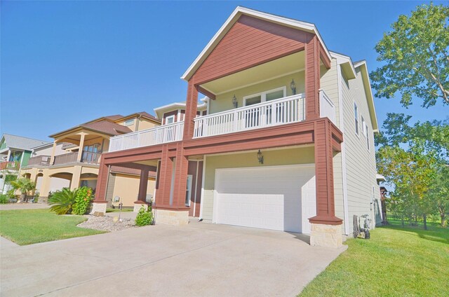 view of front of home with a garage, a balcony, and a front yard