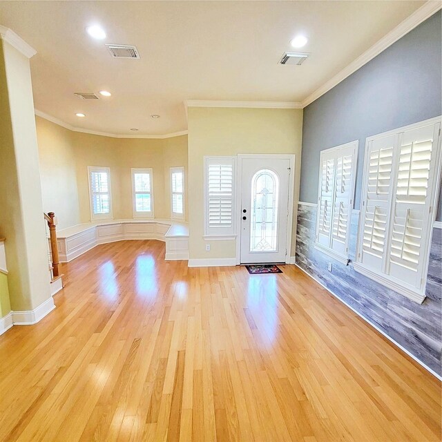 foyer featuring crown molding and light hardwood / wood-style floors