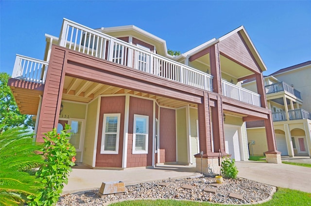 townhome / multi-family property featuring a balcony and a garage