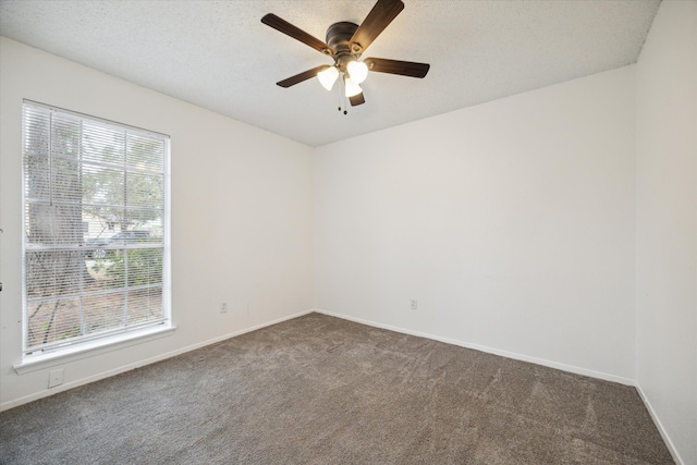 carpeted empty room featuring a textured ceiling and ceiling fan