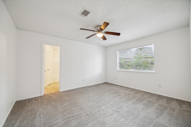 empty room featuring carpet flooring, ceiling fan, and a textured ceiling