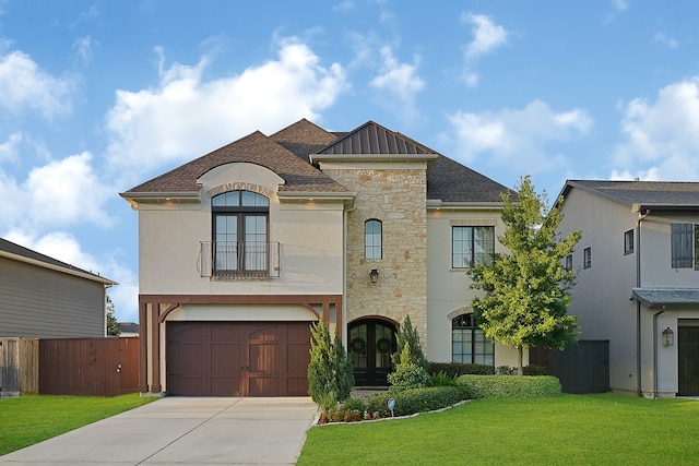 view of front of house with french doors, a front lawn, and a garage